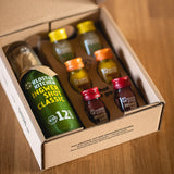 The ginger shot tasting set S unfolded on a wooden table.