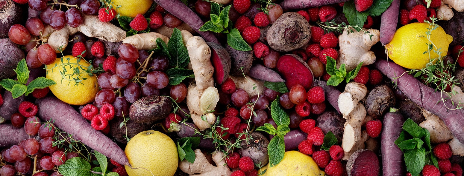 "What are micronutrients" symbol image: a colorful pile of fruits and vegetables such as raspberries, carrots, lemons and so on